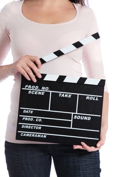 Attractive young woman holding a clapperboard. All on white background.