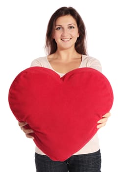 Attractive young woman holding a heart-shaped pillow. All on white background.