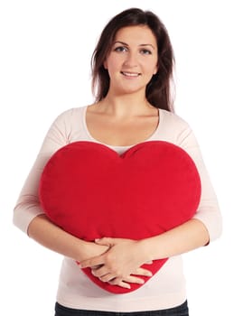 Attractive young woman holding a heart-shaped pillow. All on white background.