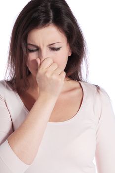 Attractive young woman sneezing. All isolated on white background.