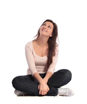 Attractive young woman sitting cross-legged. All on white background.