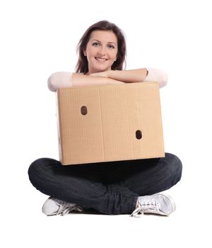 Attractive young woman holding a moving box. All on white background.