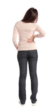 Full length shot of an attractive young woman suffering from backache. All on white background.