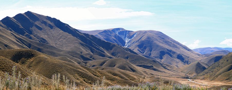Panorama of Dry Mountain Range Landscape at Lindis Pass, the highest highway, in NewZealand