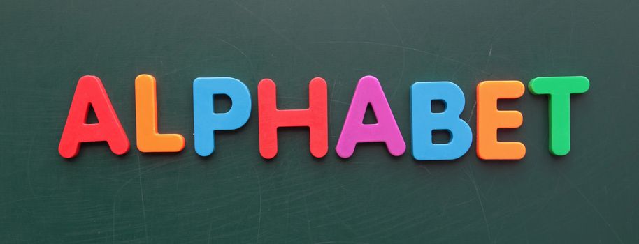 The term alphabet in colorful letters on a blackboard.