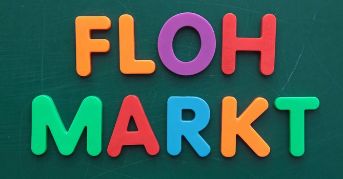 The german term for flea market in colorful letters on a blackboard.