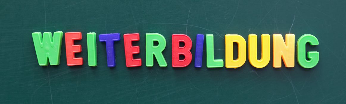 The german term for schooling in colorful letters on a blackboard.