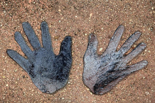 Handprints embedded in natural stone.