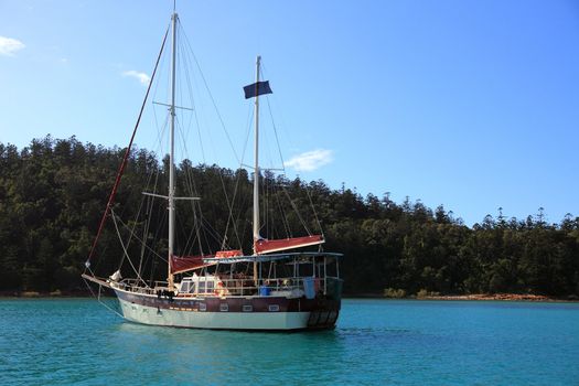 Sailboat nearby an island.