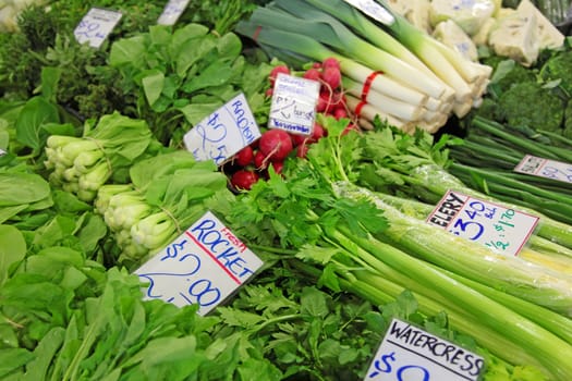 Market stall offering various vegetables.