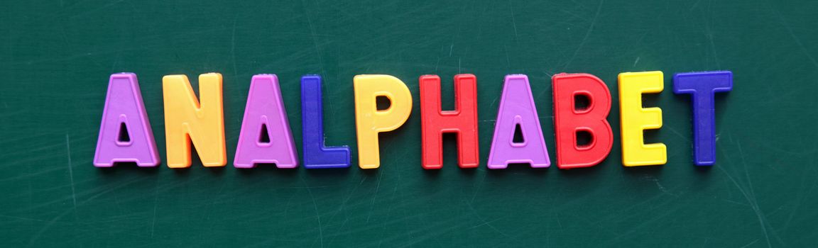 The German term analphabet in colorful letters on a blackboard.