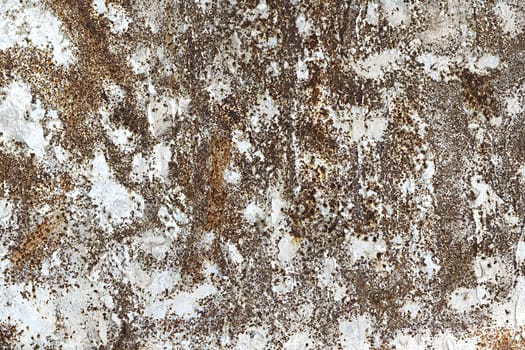 old rusty iron sheet with spots of dried cement in the background