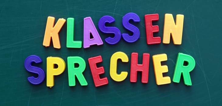 The german term for class representative in colorful letters on a blackboard.