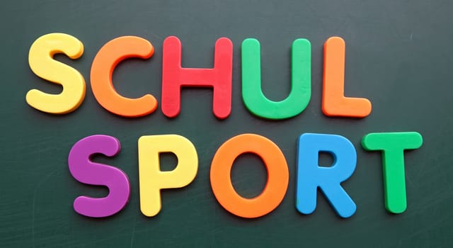 German term for school sport in colorful letters on a blackboard.