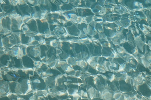 Turquoise water surface of a swimming pool.