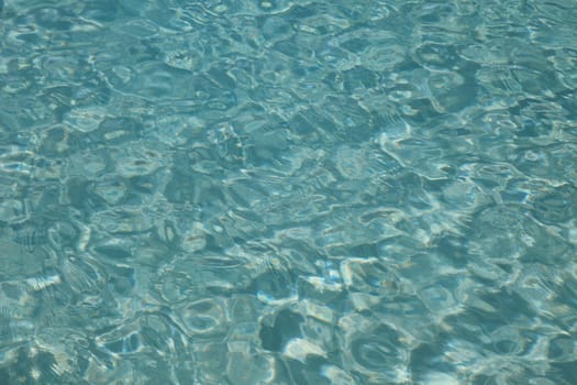 Turquoise water surface of a swimming pool.