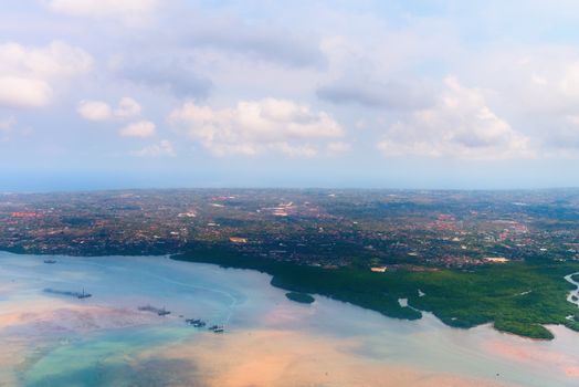 Aerial view of Denpasar on Bali showing buildings andmangrove forest