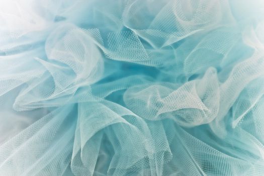 Full frame of light airy blue and white tulle

