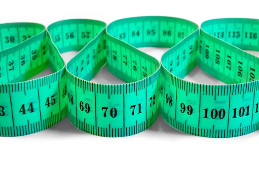 The green tape measure on a white background