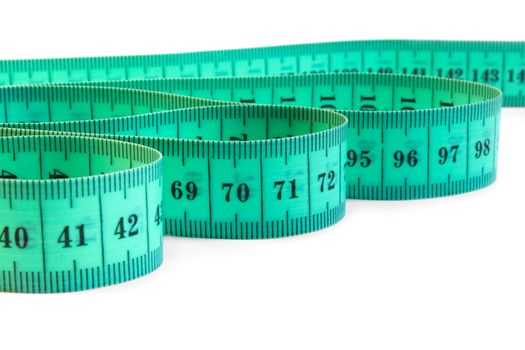 The green tape measure on a white background