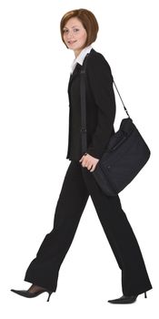 Businesswoman with a shoulder computer bag walking.