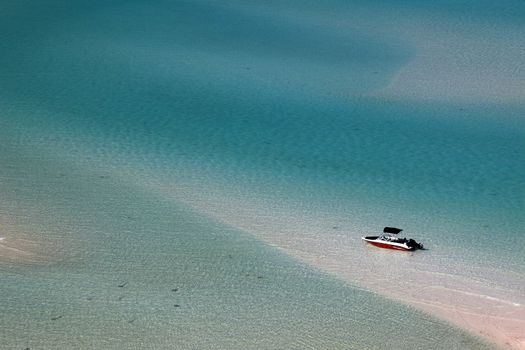 Small motor boat in shallow coast water.