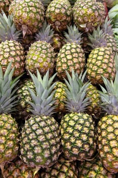 Pineapples at a market stall. Background texture.