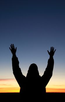 Persons silhouette in front of sunset.