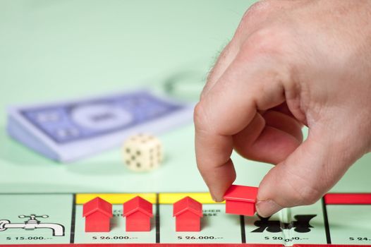 Playing with plastic houses in a board game