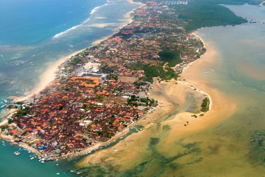 Aerial view of Nusa Dua beach on Bali showing roofs of many hotels and restaurants