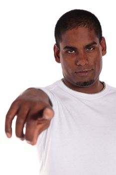 An attractive dark-skinned man pointing with finger. All on white background. 