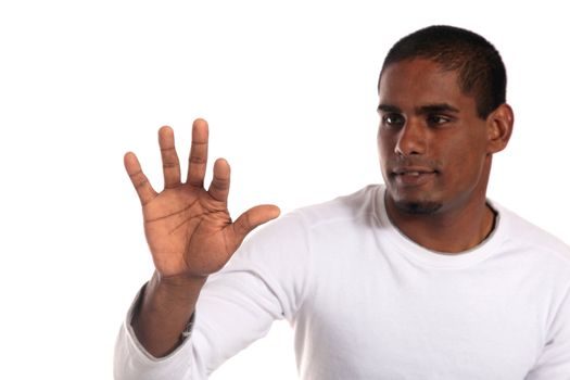 An attractive dark-skinned man pushing with his forefinger. All on white background. Image with extra copy space. Focus lies on hand.