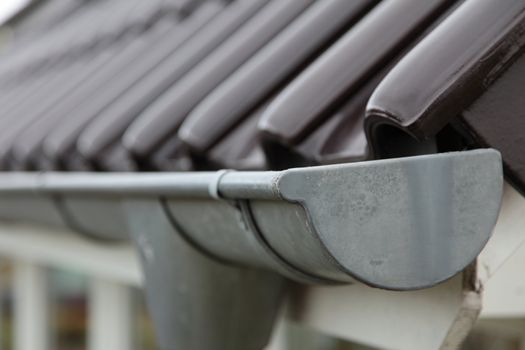 Close-up shot of a eavestrough at a standard roof.