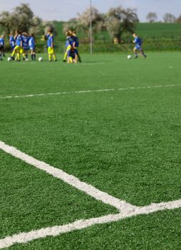 Kids during soccer training on a soccer pitch.