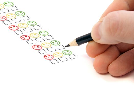 A person fills out an opinion poll. All on white background.