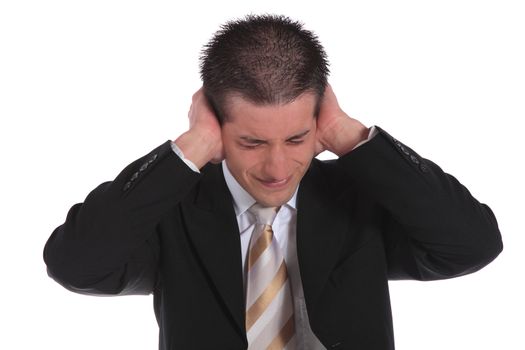 A handsome businessman pressing his hands on his ears. All on white background.