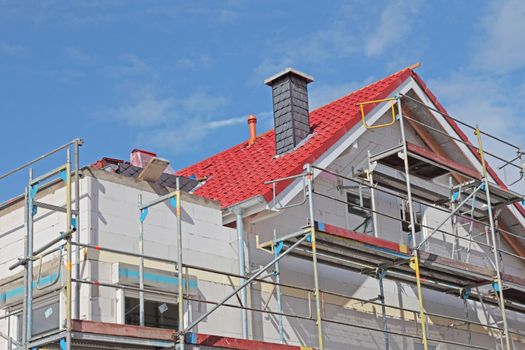 Shell construction of a typical new residential building with scaffolding.