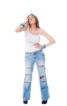 Young female standing on white background with torn jeans, holding her head