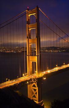 Golden Gate Bridge Night Vertical With Lights of San Francisco California in background