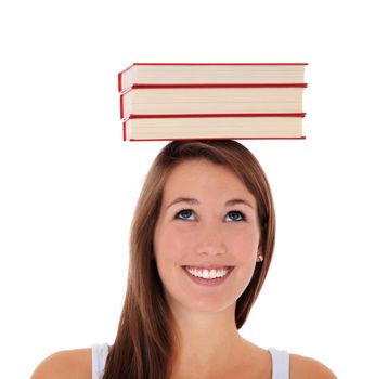 Attractive young woman balancing books on her head. All on white background.