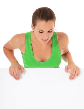 Attractive young woman looking down blank white sign. All on white background.