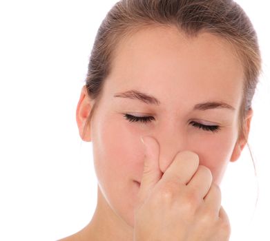 Attractive young woman smells something awful. All on white background.