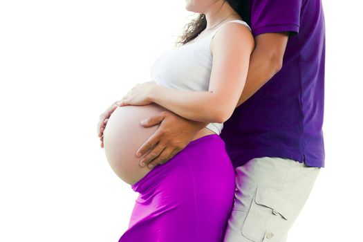 Pregnant woman holding hands around her belly 