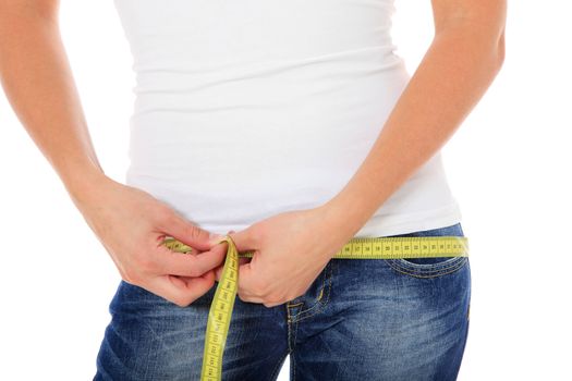 Attractive young woman using measuring tape. All on white background.