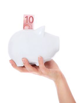 A persons hand holding piggy bank. All on white background.