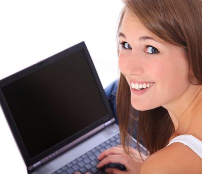 Attractive young woman using laptop. All on white background.