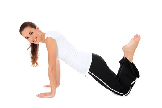 Attractive young woman in sports wear doing gymnastics. All on white background.
