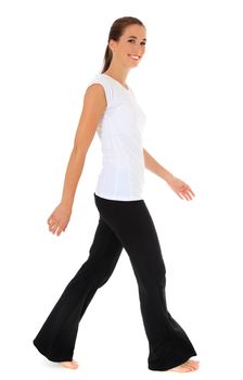 Attractive young woman walking  in sports wear. All on white background.