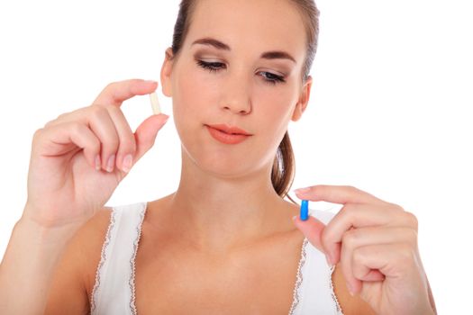 Attractive young woman taking pill. All on white background.