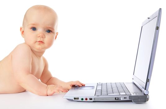 Newborn child playing with a notebook / laptop. All isolated on white background.